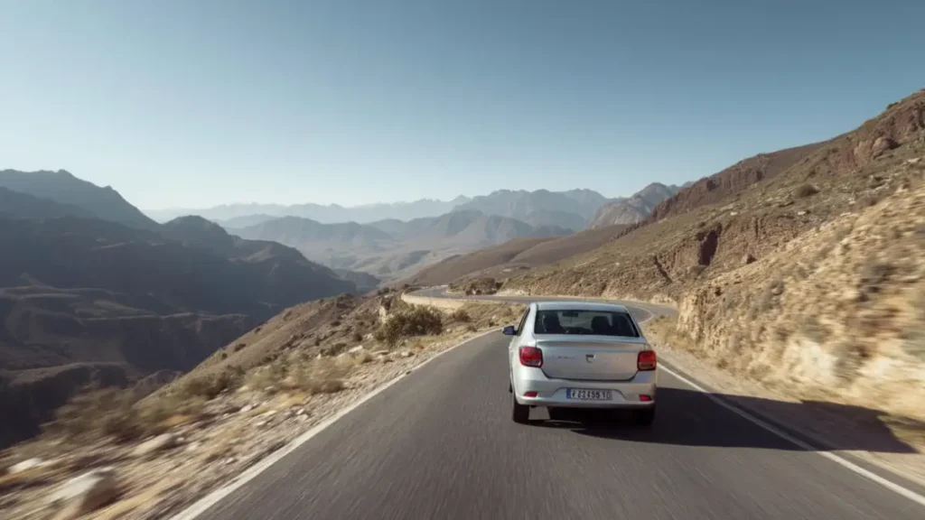 Car driving on a winding road in the Atlas Mountains in Morocco
