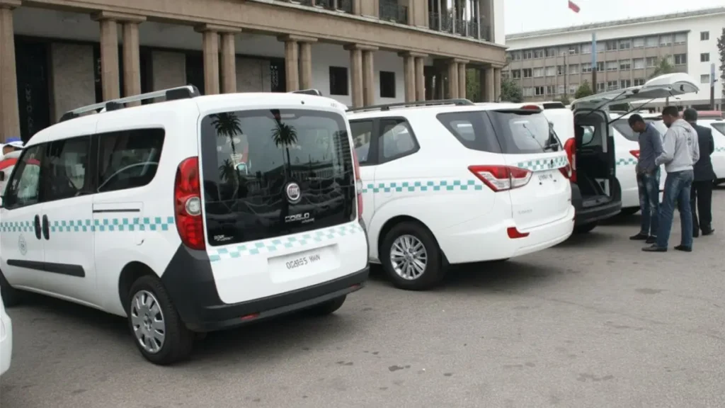 White grand taxis waiting at a taxi stand in Morocco