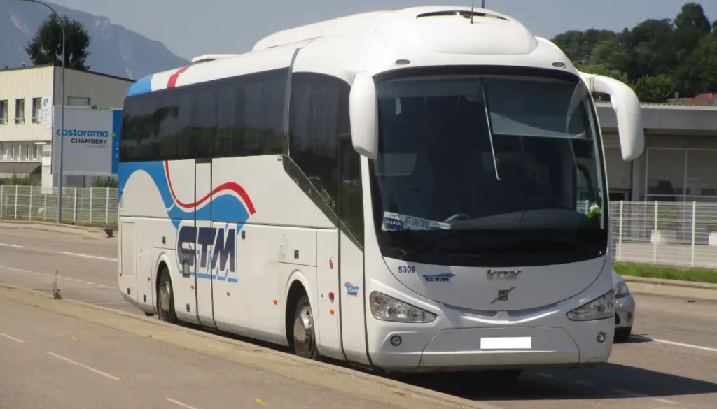 Long‑distance bus at a station in Morocco with passengers and luggage