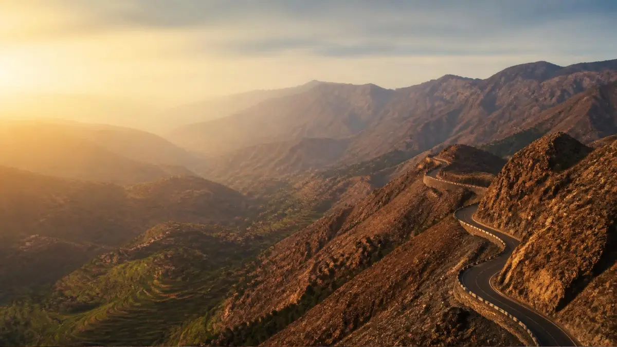 Winding road crossing a high pass in the Atlas Mountains of Morocco at sunset