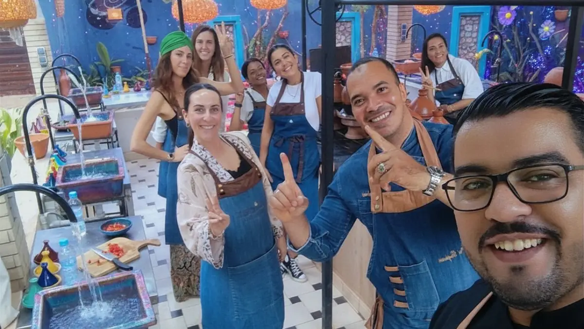 Farm-to-table cooking class near Marrakech with fresh herbs, vegetables, bread, tagine ingredients and mint tea in a countryside kitchen.