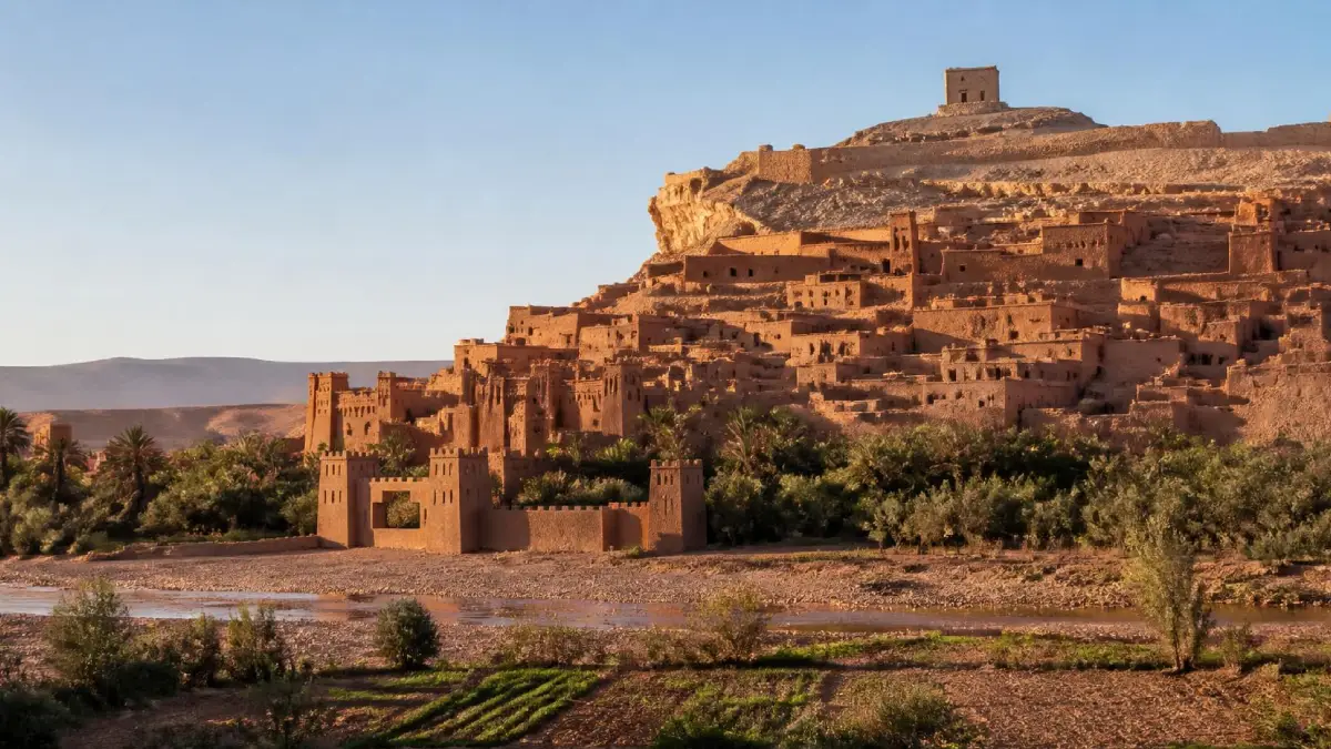 Aït Ben Haddou ksar glowing in early-morning light across the riverbed