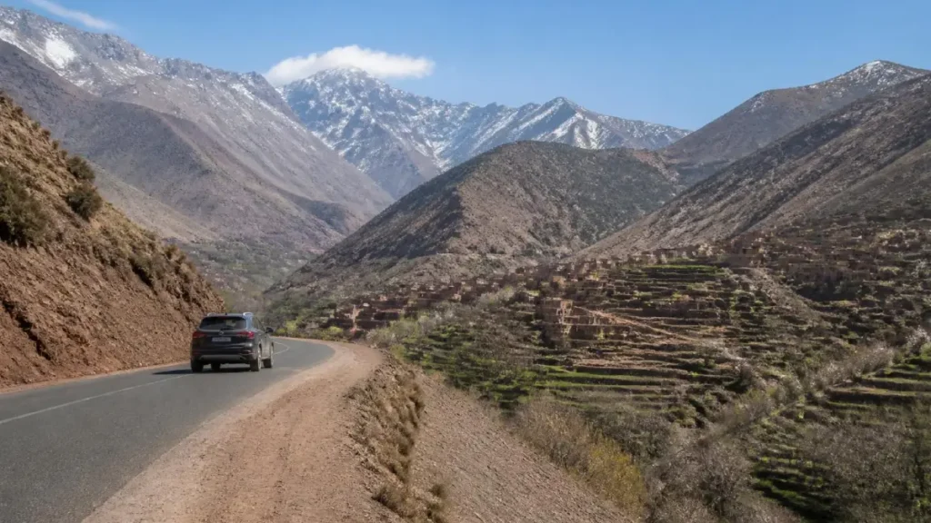 Paved mountain road from Marrakech to Imlil through the High Atlas Mountains with Amazigh villages and rugged Moroccan landscapes