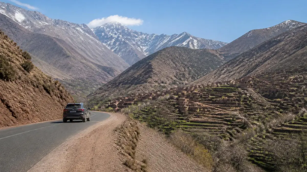 Paved mountain road from Marrakech to Imlil through the High Atlas Mountains with Amazigh villages and rugged Moroccan landscapes