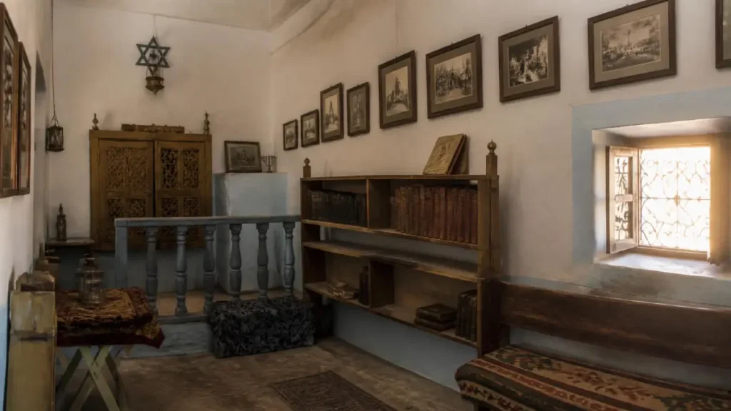 Historic synagogue interior with books and Jewish artifacts in Ouarzazate