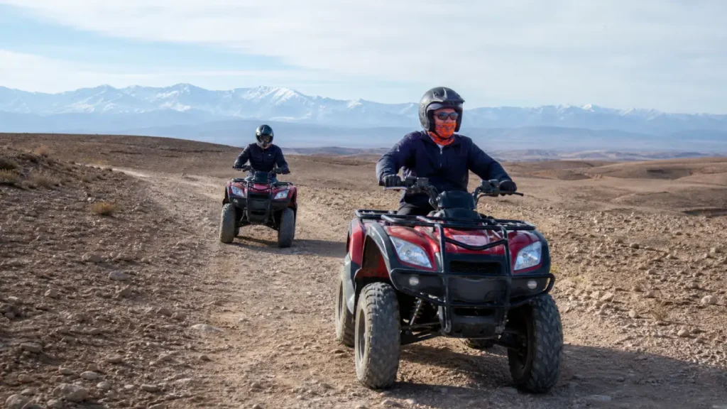 Quad-bike riders following a guide on an established Agafay trail