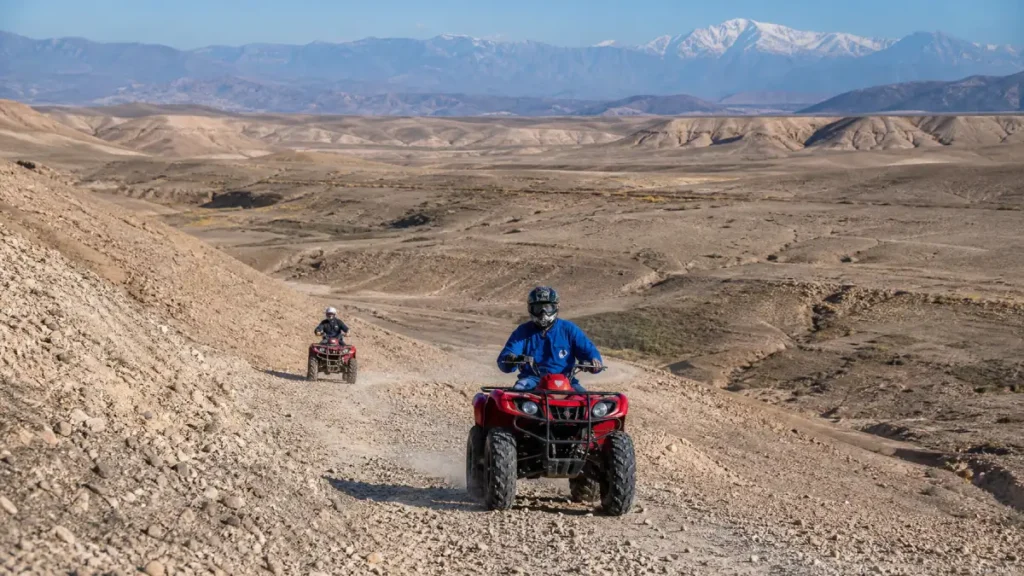 Quad-bike rider navigating rocky terrain in Agafay Desert