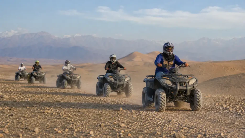 Small shared quad-biking group following a guide in Agafay
