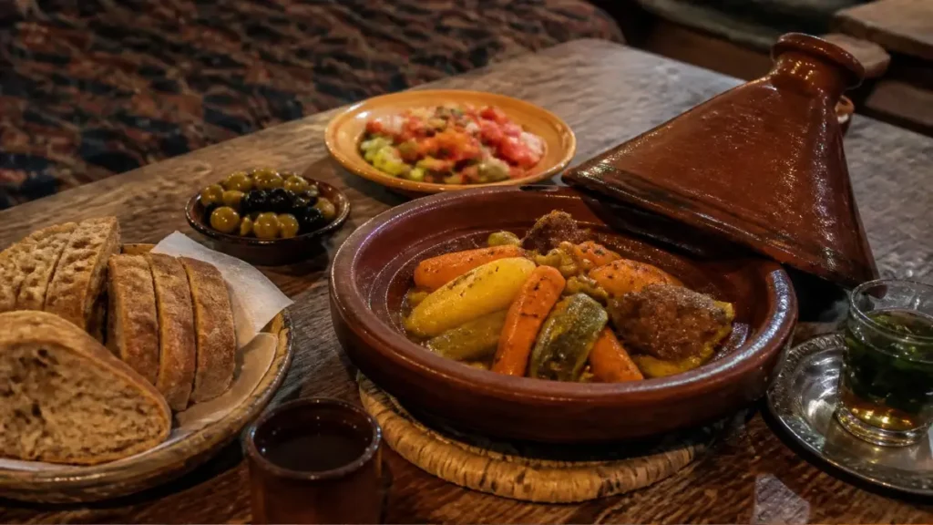 Traditional Moroccan tagine, bread, salad, and mint tea served near Aït Ben Haddou