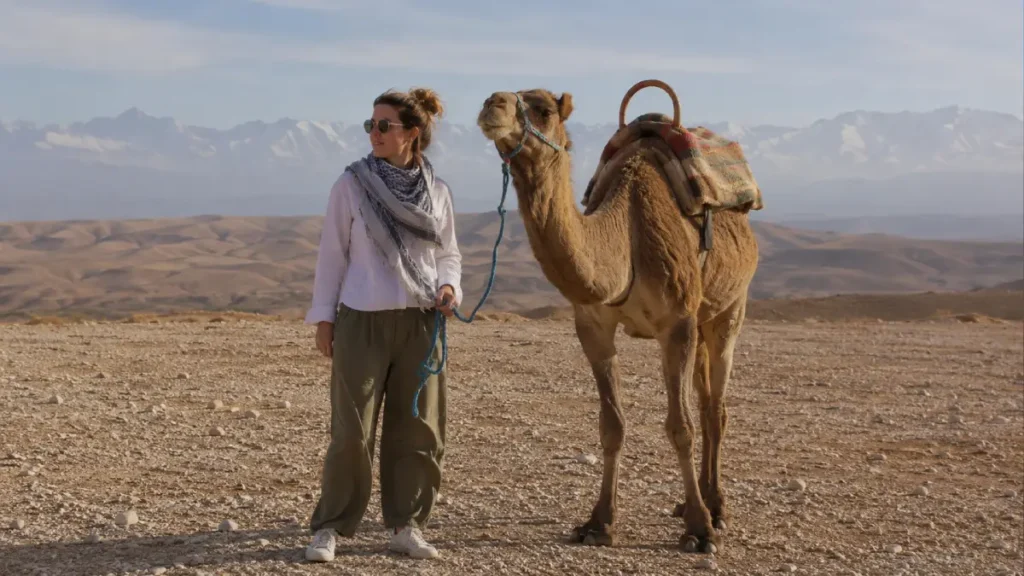 Traveler wearing practical clothing for an Agafay camel ride