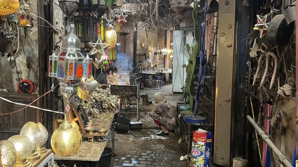Artisans working among metal lanterns in Souk Haddadine, Marrakech