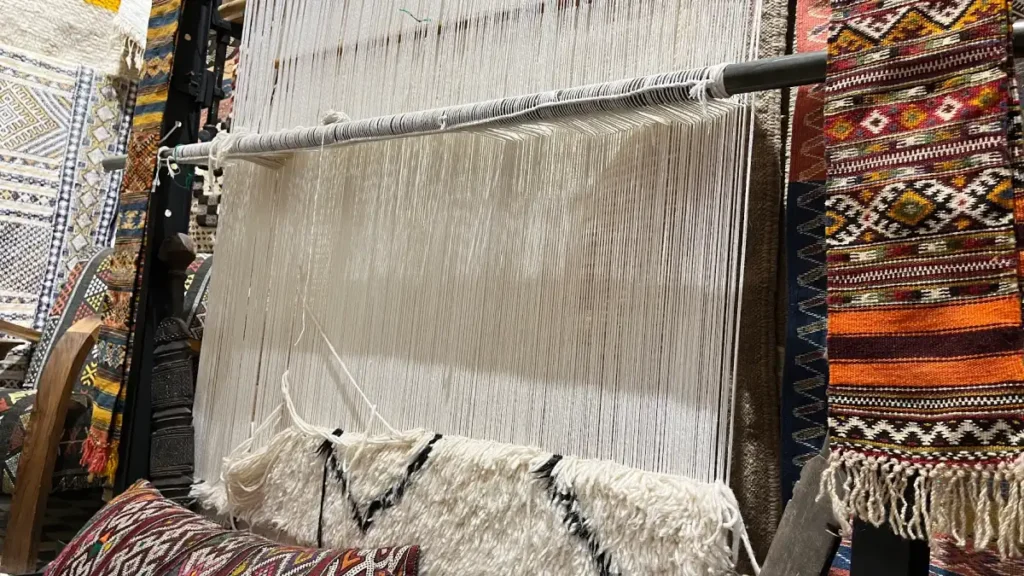Moroccan rug being woven on a traditional loom in Marrakech