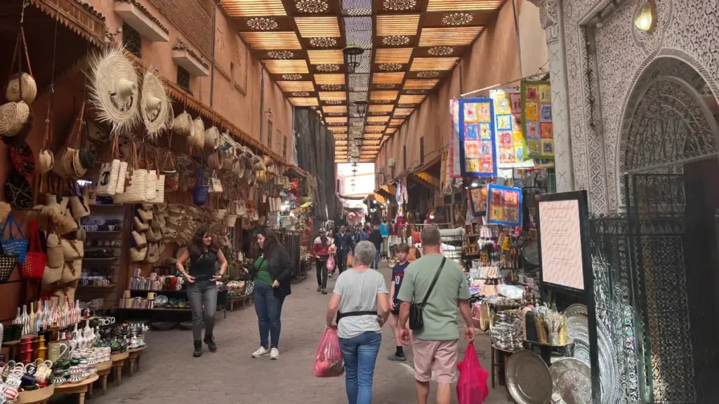 Shoppers walking past craft stalls in Souk Semmarine, Marrakech