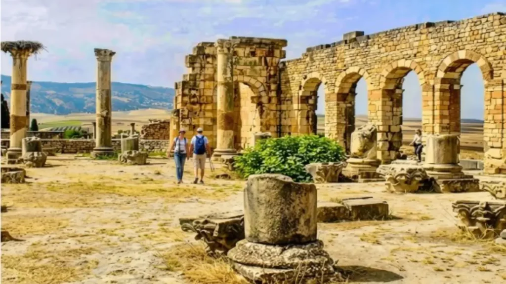 Visitors walking through the exposed archaeological ruins of Volubilis