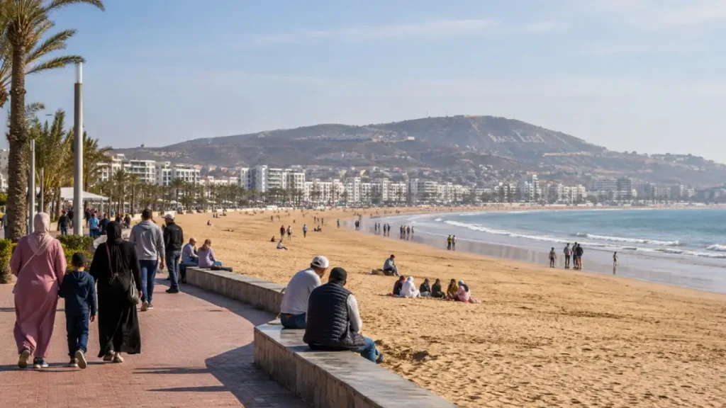 Families and travellers enjoying mild November sunshine beside Agadir beach