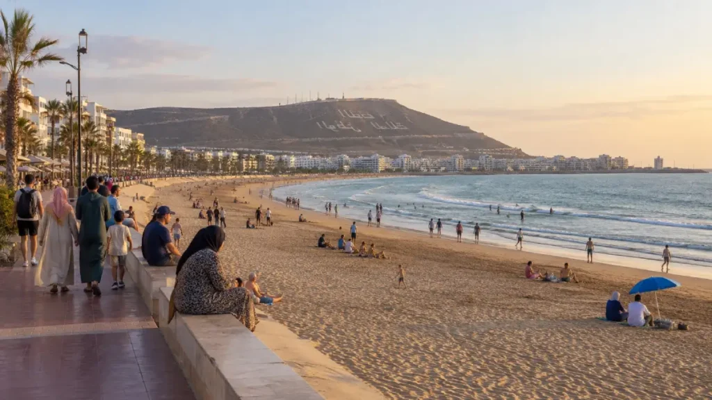 Families and travellers enjoying Agadir beach during warm September weather