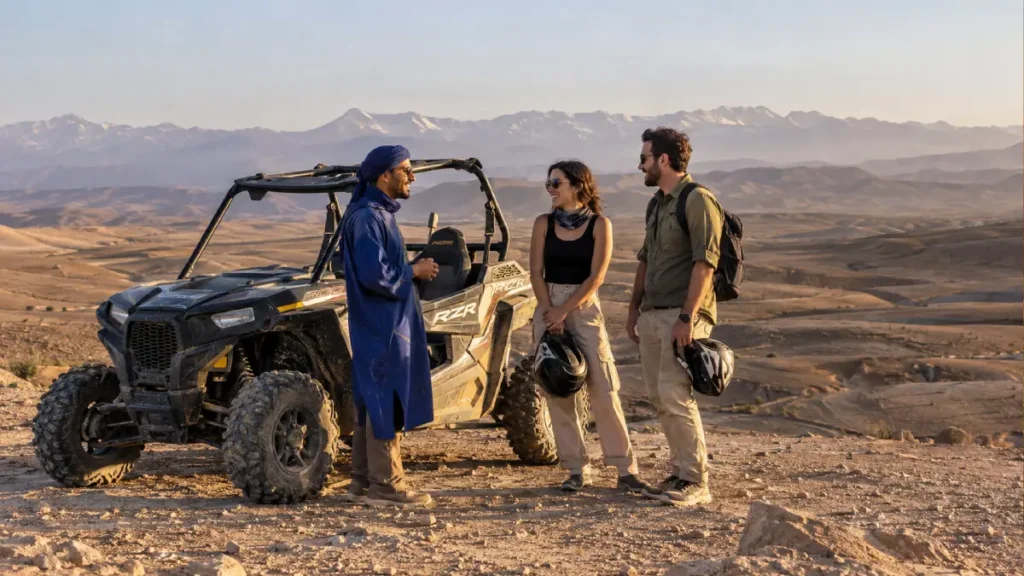 Travelers with a local guide beside a buggy in Agafay near Marrakech with the Atlas Mountains behind