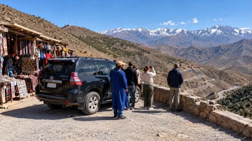Travelers stopping at a Tizi n’Tichka viewpoint on the Marrakech to Zagora route