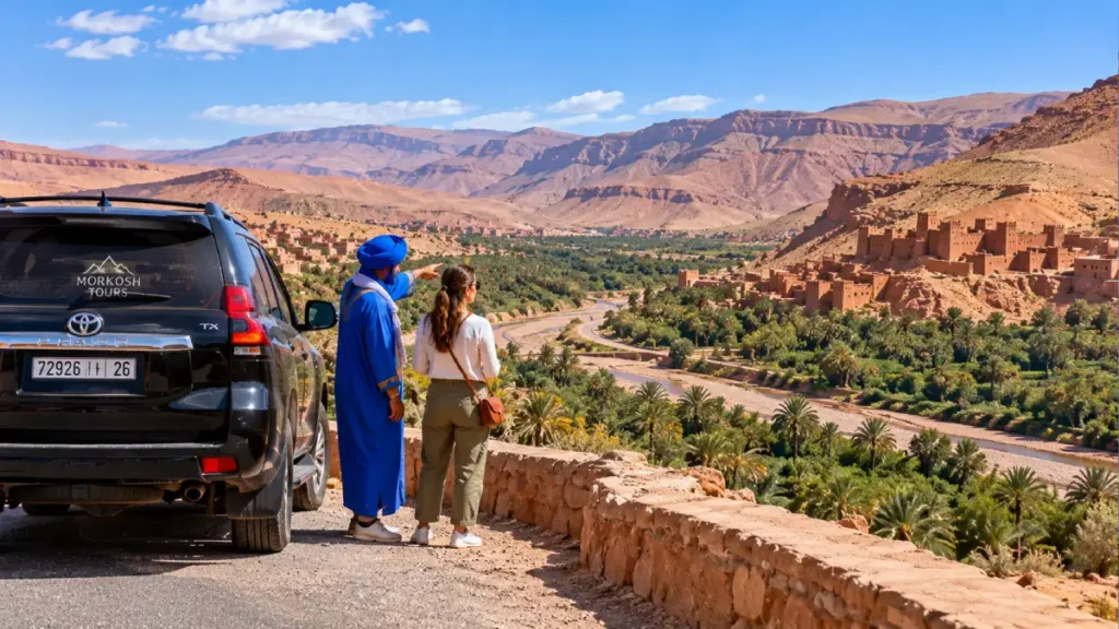 3-day desert tour from Fes with black Toyota Prado TX, private guide and traveler overlooking a palm-filled valley and traditional kasbahs in southern Morocco